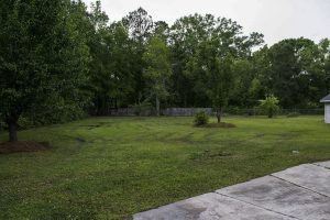 Displaying land home exterior with residential yard details