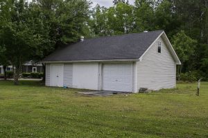 Displaying land home side exterior with open yard view