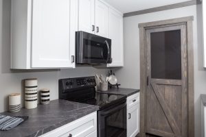 Showing farmhouse kitchen island with open home layout