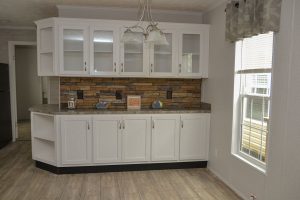 Displaying white country kitchen with cabinet storage
