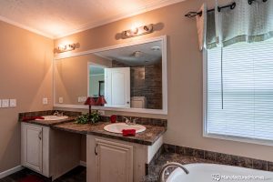 Showing spacious bathroom interior with modern cabinetry setup